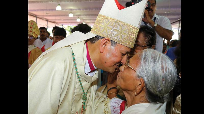 Metropolitan Joseph Kalathiparambil kisses mother Thressia Avarachan after the ordaining ceremony in Kochi on Sunday. (Photo: DC)