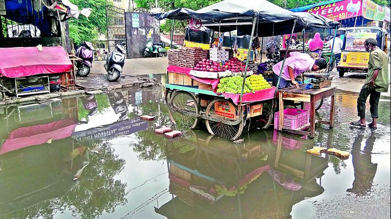 It is a miserable experience for the patients visiting the King Koti government hospital as heavy rains resulted in water logging right in front of the gate and also caused hardship to the regular commuters on Monday. (Photo: DC)
