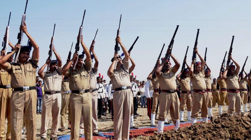 Police personnel giving a gun-salute to mortal remains of CRPF H C Nandram Atram who was killed in a Naxal attack in Sukma district of Chhattisgarh. (Photo: PTI)