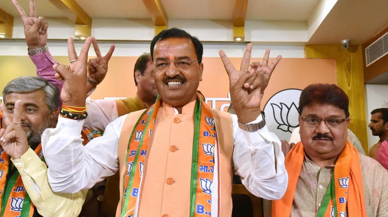 UP BJP President Keshav Prasad Maurya flashes victory sign with party workers at a press conference after the partys victory in State Assembly elections in Lucknow. (Photo: PTI)