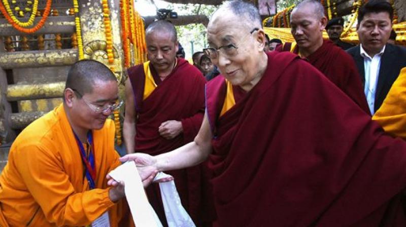 Devotees pay respects to Tibetan spiritual leader Dalai Lama at the Mahabodhi temple. (Photo: AP)
