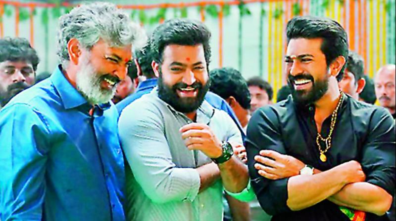 S.S. Rajamouli, Jr NTR and Ram Charan enjoying a light moment during the launch.