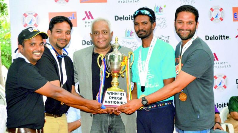 Hari Karra (centre) of Deloitte presents trophy to the Vizag team in the Deloitte Monsoon Regatta.