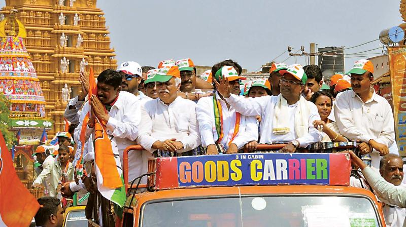 Chief Minister Siddaramaiah and other Congress leaders during a road show organised as part of the bypoll campaign in Nanjangud on Thursday.