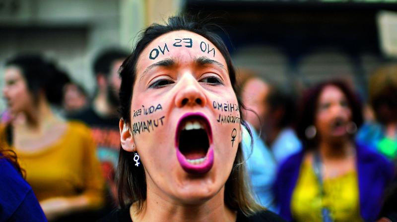 A woman shouts slogans at a protest in Madrid after five men accused of gangrape were sentenced to nine years in jail for â€œsexual abuse,â€ avoiding charge of rape.