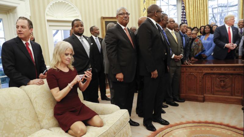 Donald Trumps senior advisor Kellyanne Conway kneeling on a White House sofa with her shoes on. (Photo: AP)