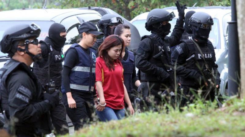 Indonesian suspect Siti Aisyah, center, in the ongoing assassination investigation, is escorted by police officers as she arrives at Sepang court in Sepang. (Photo: AP)