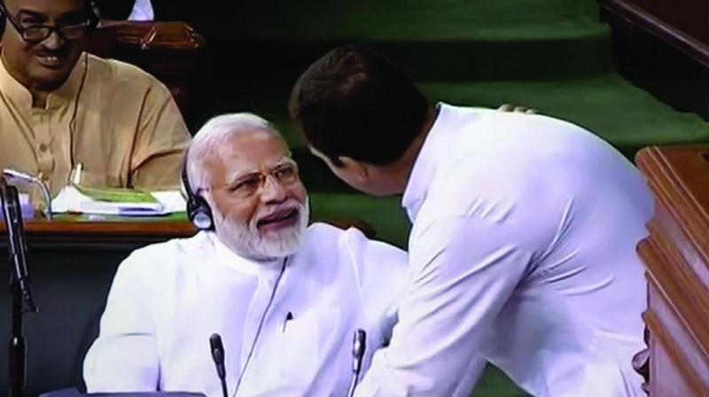 Congress president Rahul Gandhi with Prime Minister Narendra Modi after his speech in the Lok Sabha on the no-confidence motion during the Monsoon Session of Parliament. (Photo: PTI)