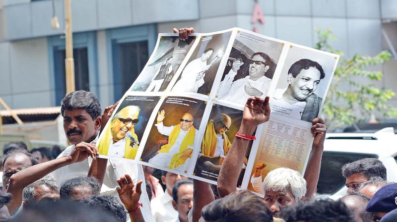 DMK supporters raise a placard outside the hospital where DMK chief M. Karunanidhi is being treated for fever due to urinary tract infection, in Chennai, on Saturday.  (Photo:DC)