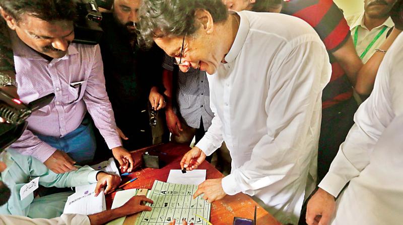 Tehreek-e-Insaf party chief Imran Khan casts his vote at a polling station in Islamabad, on Wednesday. (Photo: AP)