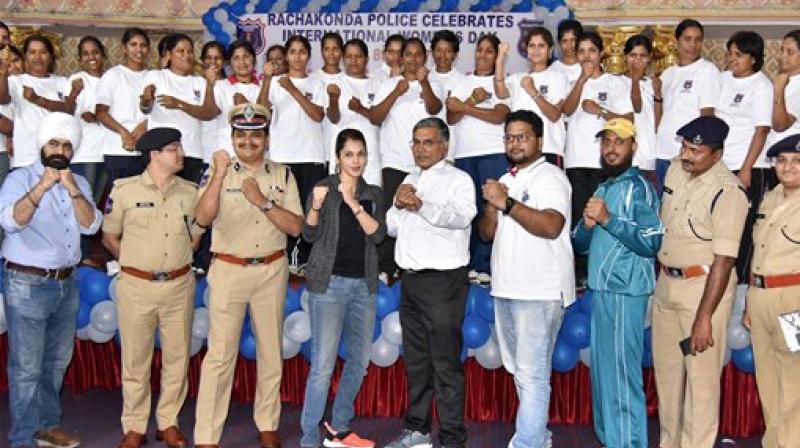 Bollywood actress Isha Koppikar and IPS officer Mahesh Bhagwat pose for a photograph after a training session for the women cops in Hyderabad on International Womens Day on Wednesday. (Photo: PTI)