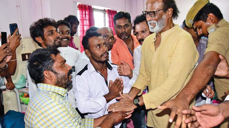 An injured person at Thoothukudi government medical college hospital holds Rajinikanths hands when he visited the hospital on Wednesday.  (Photo:DC)
