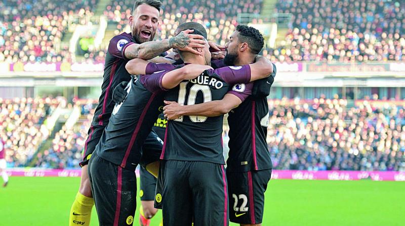 Manchester Citys Sergio Aguero (centre) celebrates scoring his teams second goal with team mates in their English Premier League match against Burnley at Turf Moor on Saturday. City won 2-1 (Photo: AFP)