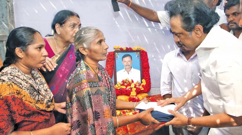 M.K. Stalin handing over relief to the kin of a deceased farmer in Erode, on Saturday. (Photo: DC)