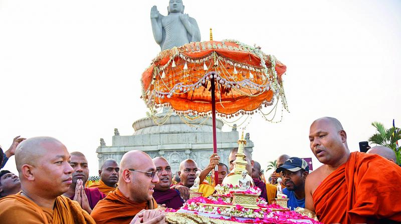 Monks carry the Holy relics of Lord Buddha during a procession at the Hussainsagar lake.  (Gandhi)