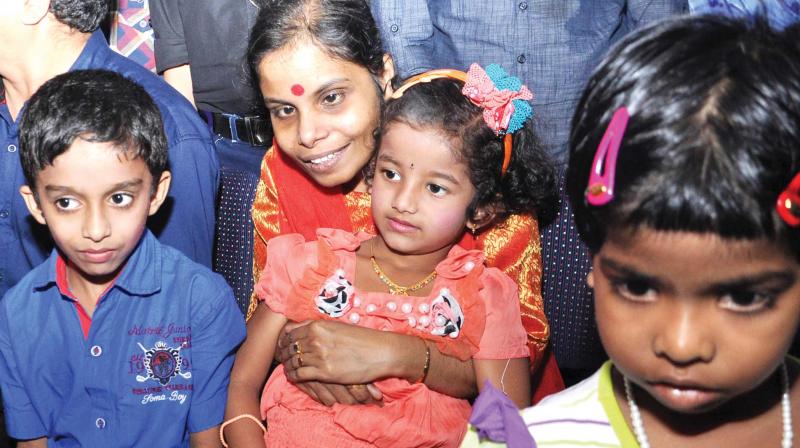 Visually challenged playback singer Vaikom Vijayalakshmi along with cochlear implanted children at a union organised in Kochi.  (DC  file photo)