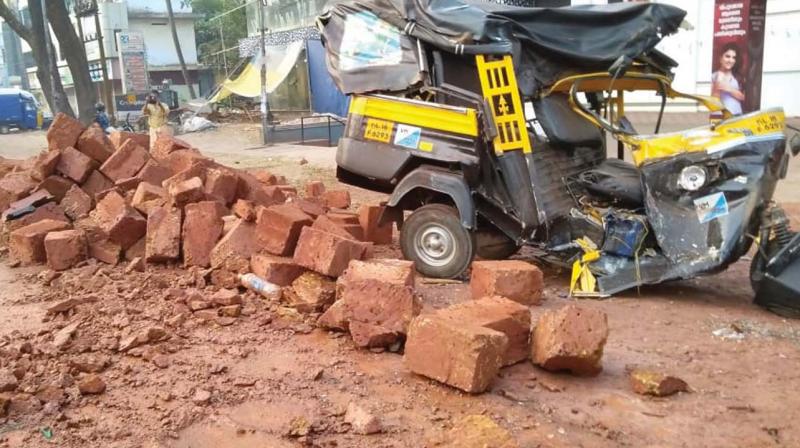 The mangled remains of an auto rickshaw after a laterite stone-laden lorry fell over it in Vadakara on Thursday