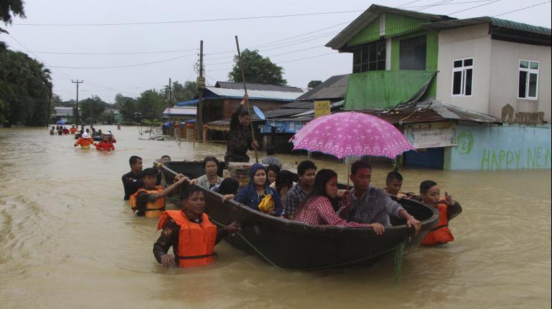 Some stranded people were plucked from the churning waters by rescuers in boats, while volunteers used rafts made from barrels and pieces of wood. (Photo: AP)