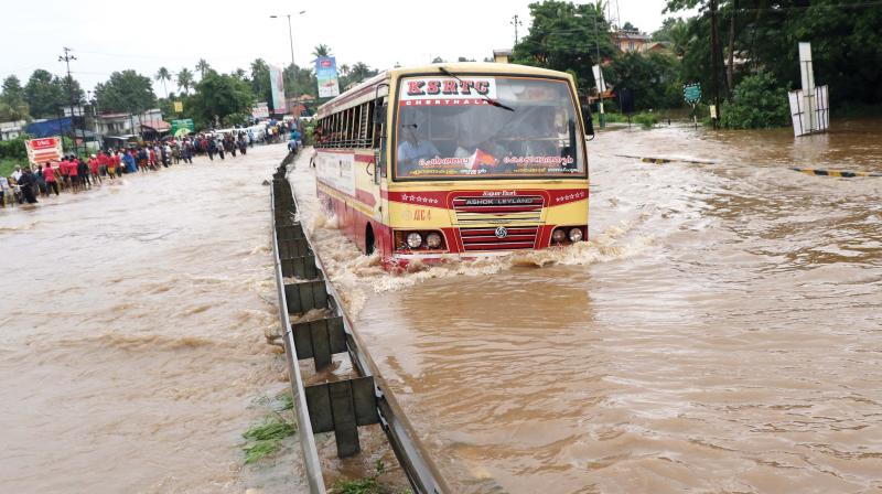 An RTC bus tries to navigate through the heavily flooded Chalakudy-Muringoor national highway  on Thursday. (Image  ANUP K. VENU)
