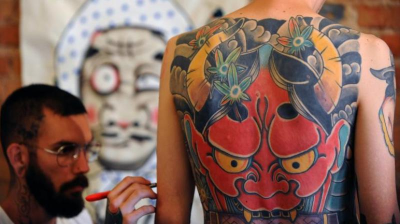Just 43 percent of tattoo artists surveyed for the study said they had received training on how to handle skin with moles, spots or other skin lesions. (Photo: AFP)