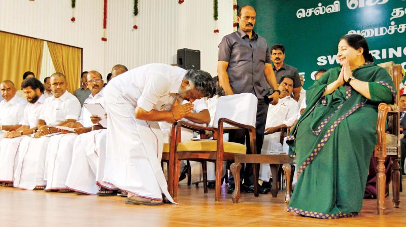 A file photo of AIADMK leaders touching J. Jayalalithaas feet.