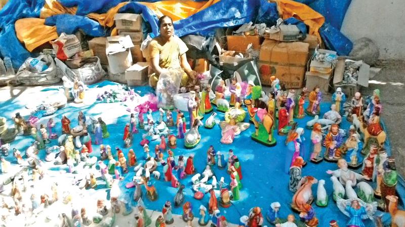 A vendor awaiting customers to buy the clay dolls for Chirstmas in Puducherry on Saturday. (Photo: DC)