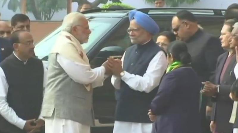 After verbal tiff, PM Modi, Manmohan Singh come face to face, shake hands