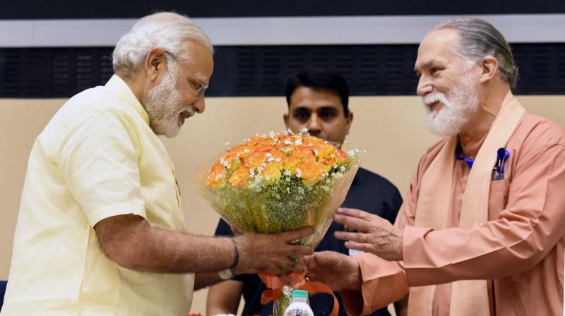 Prime Minister Narendra Modi being welcomed by Swami Vishwananda giri at the release of Special Commemorative Postage Stamp on 100 years of Yogoda Satsang Math, at Vigyan Bhawan, in New Delhi. (Photo: PTI)