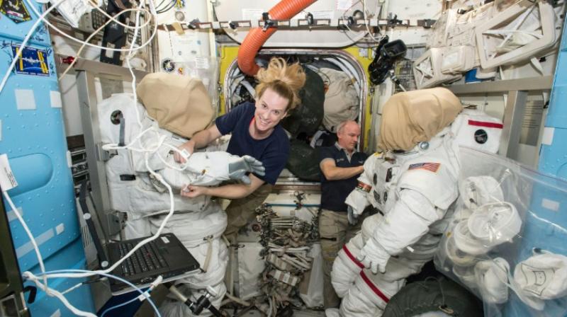 Expedition 48 crew members Kate Rubins and Jeff Williams (R) of NASA outfit spacesuits inside of the Quest airlock aboard the International Space Station in 2016 (Photo: AFP)