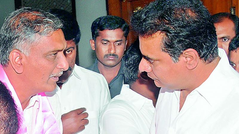 K.T. Rama Rao and T. Harish Rao have a chat at TRS Bhavan on Wednesday. 	 DC