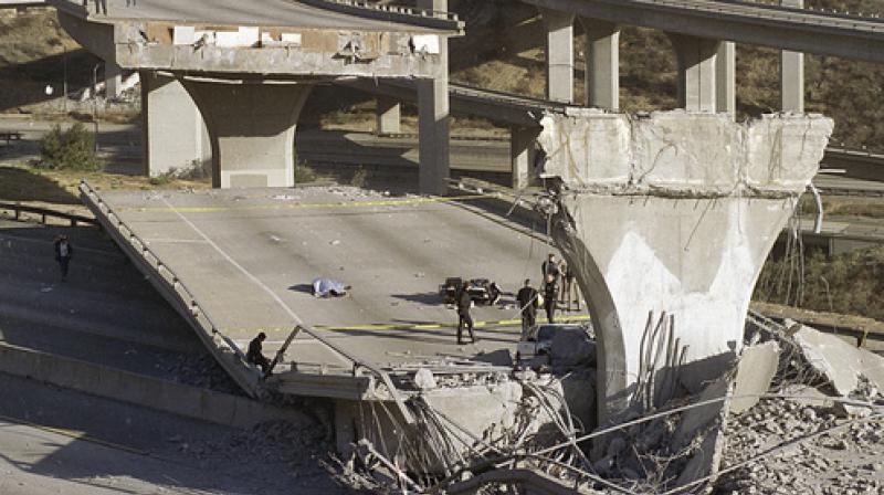 In this Jan. 17, 1994, file photo, the covered body of Los Angeles Police Officer Clarence Wayne Dean, 46, lies near his motorcycle which plunged off the State Highway 14 overpass that collapsed onto Interstate 5, after a magnitude-6.7 Northridge earthquake in Los Angeles. A new study says an earthquake fault running from San Diego to Los Angeles is capable of producing a magnitude-7.4 temblor that could affect some of the most densely populated areas in California. (AP Photo/Doug Pizac, File) In this Jan. 17, 1994, file photo, the covered body of Los Angeles Police Officer Clarence Wayne Dean, 46, lies near his motorcycle which plunged off the State Highway 14 overpass that collapsed onto Interstate 5, after a magnitude-6.7 Northridge earthquake in Los Angeles. A new study says an earthquake fault running from San Diego to Los Angeles is capable of producing a magnitude-7.4 temblor that could affect some of the most densely populated areas in California. (AP Photo/Doug Pizac, File)