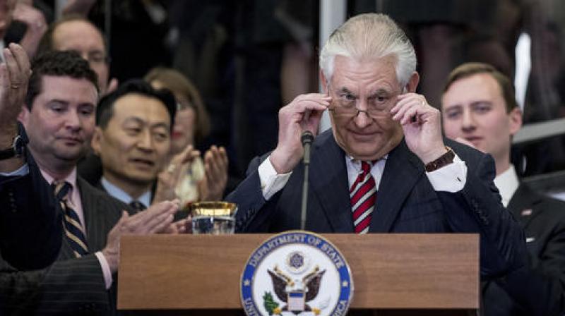 Secretary of State Rex Tillerson removes his reading glasses after speaking to State Department employees upon arrival at the State Department in Washington. (Photo: AP)