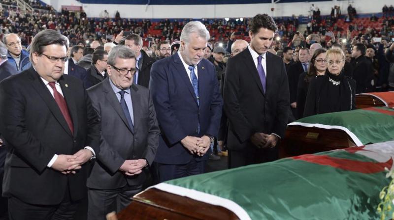 Canada Prime Minister Justin Trudeau, Quebec premier Philippe Couillard, Quebec city mayor Regis Labeaume and Montreal mayor Denis Coderre pay their respects to three victims of the mosque shooting during their funeral in Montreal. (Photo: AP)