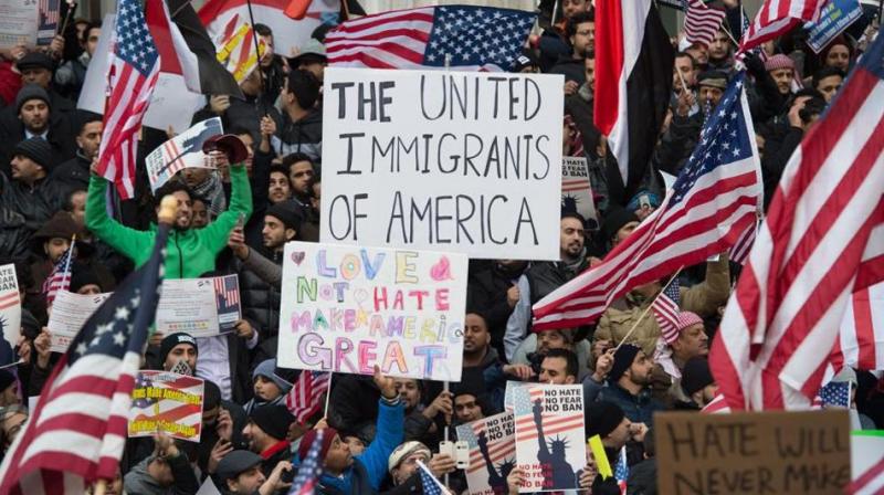 People rally with flags at Brooklyn Borough Hall as Yemeni bodega and grocery-stores shut down to protest US President Donald Trumps Executive Order banning immigrants and refugees from seven Muslim-majority countries, including Yemen in New York. (Photo: AFP)