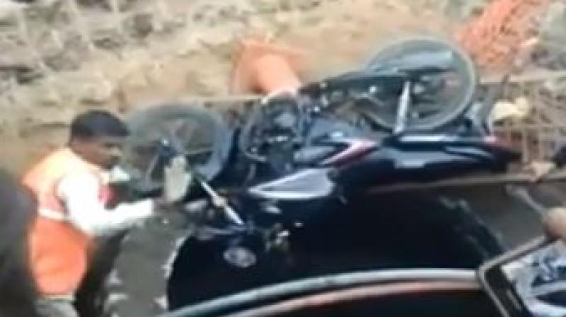 A video, which has gone viral, shows the bike lying next to the manhole, while passersby have gathered around the manhole with some trying to lower a thick rope and a ladder, in a bid to rescue the man. (Photo: SCreengrab)