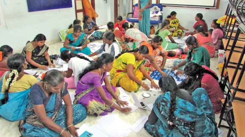 Women taking training in producing paper and jute bags at RSETI of IOB at Thanjavur.	 DC