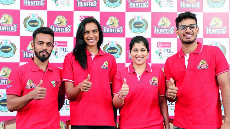 Ace shuttler P. V. Sindhu (second from left) poses with her teammates from the Hyderabad Hunters Arun George (left), Meghana Jakkampudi (second from right) and Rahul Yadav (right) during a press conference in Hyderabad on Monday.
