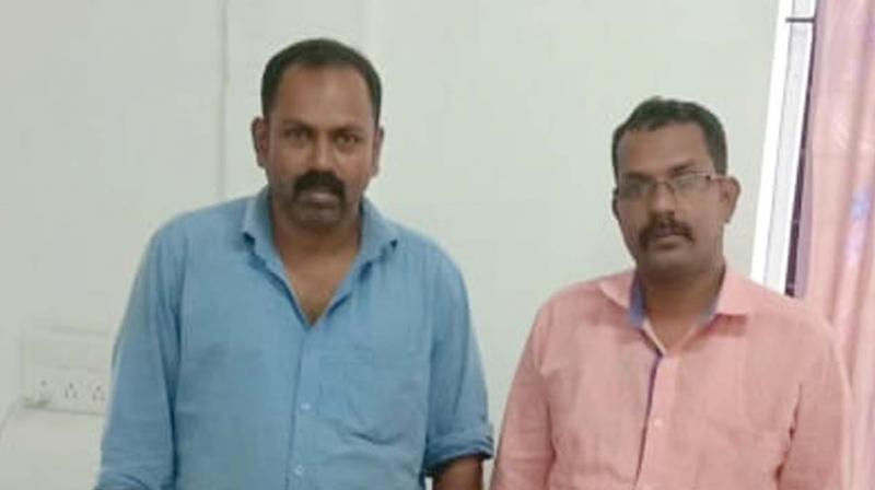 The arrested Suresh and Gireeshan with the seized liquor at Kaiveli near Vadakara