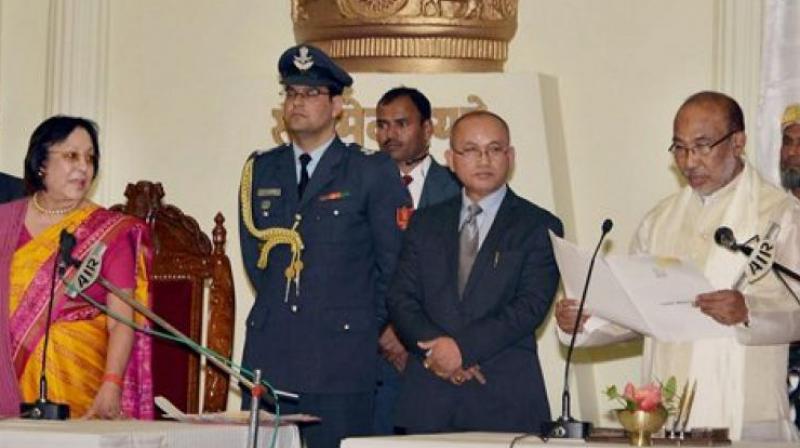 Manipur Governor Najma Heptulla administering oath of office to new Chief Minister N Biren Singh during a ceremony in Imphal on Wednesday. (Photo: PTI)