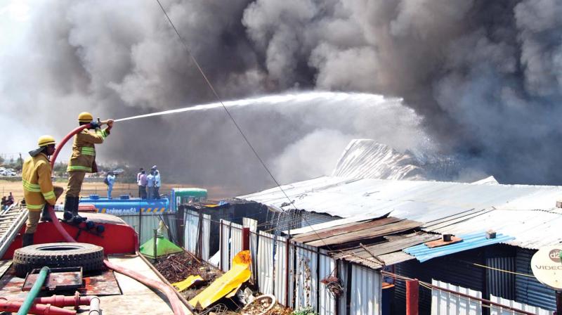 Fire and rescue personnel put out the fire at air-conditioner manufacturing unit in Vanagaram on Wednesday. (Photo: DC)