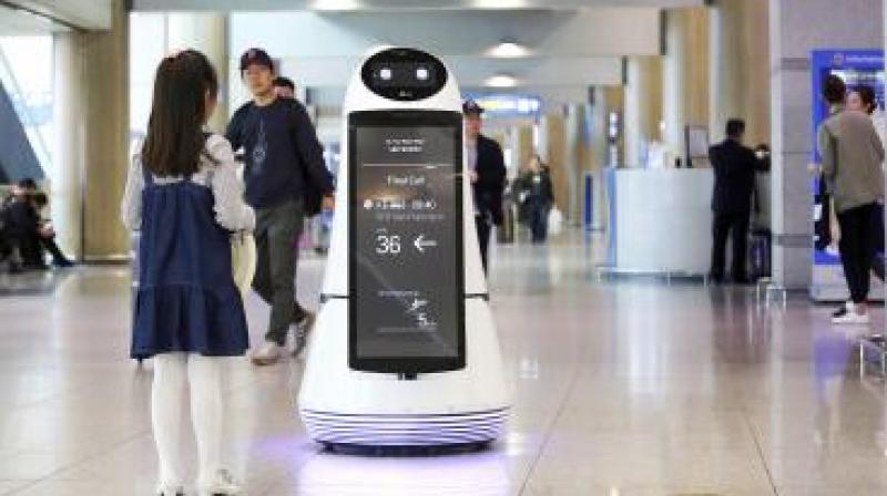 Troika, a robot made by LG Electronics, serves visitors at Incheon International Airport in South Korea on April 10. Photo: AP