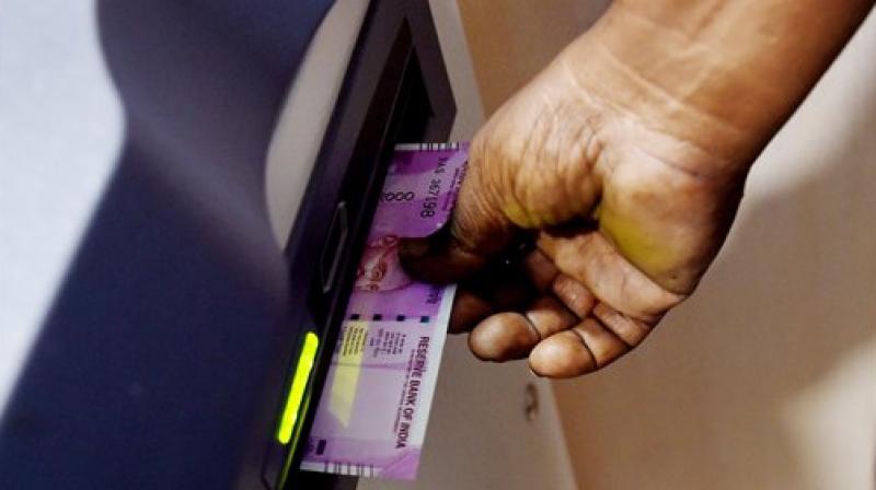 A person withdraws new 2000 note from an ATM. (Photo: