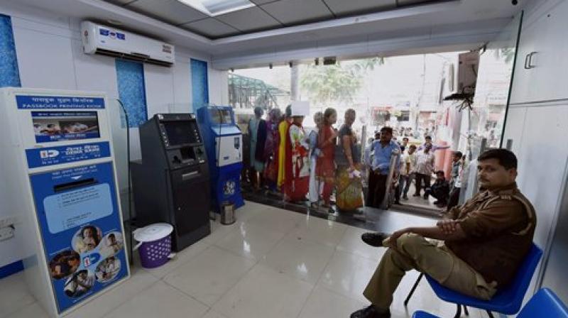 People queue up outside an out of service ATM in Lucknow. (Photo: PTI)