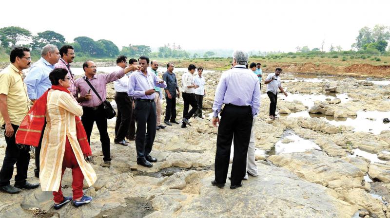 The Central team walks through the dried up River Kabani at Kolavally near Padichira  on the Kerala-Karnataka border in Wayanad on Thursday.