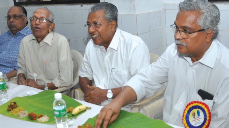 Chief Minister Pinarayi Vijayan, along with writer M.K. Sanu and CPI leader Benoy Viswam, at the centenary celebration of inter-dinning organised by Sree Narayana Sahodara Sangham in Kochi on Tuesday.