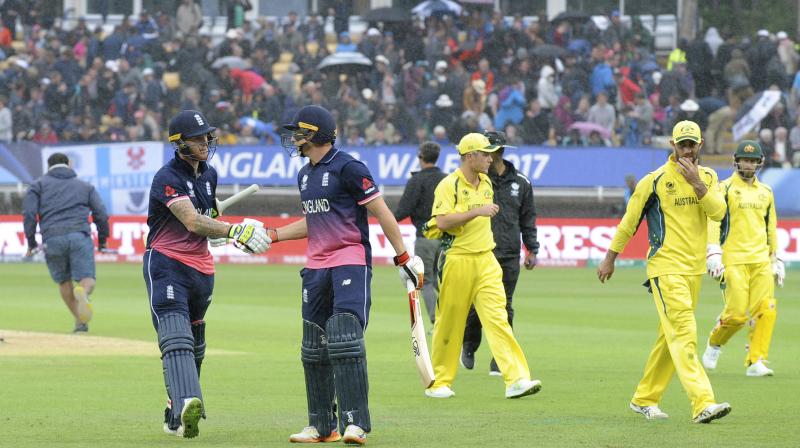 Englands Ben Stokes, left, is congratulated by Englands Jos Buttler as players leave the field due to rain during the ICC Champions Trophy match between England and Australia at Edgbaston in Birmingham, England, Saturday, June 10, 2017 (Photo: AP)
