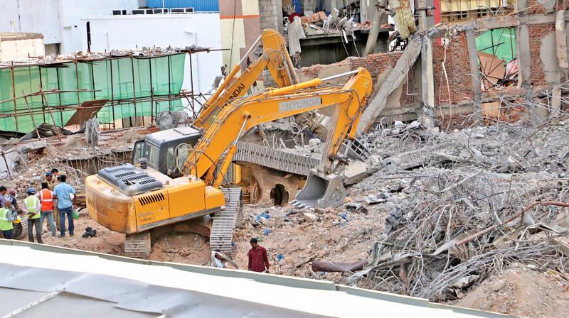 Chennai Silks building being pulled down on Saturday. (Photo: DC)