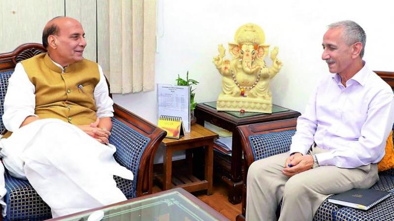 Dineshwar Sharma with Union home minister Rajnath Singh in New Delhi on Monday.
