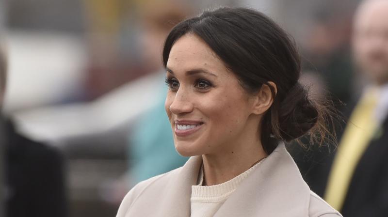 US actress and fiancee of Britains Prince Harry Meghan Markle leaves the iconic tourist attraction, Titanic Belfast, in Belfast on March 23, 2018, during the royal couples first joint visit to Northern Ireland. (Photo: AFP)