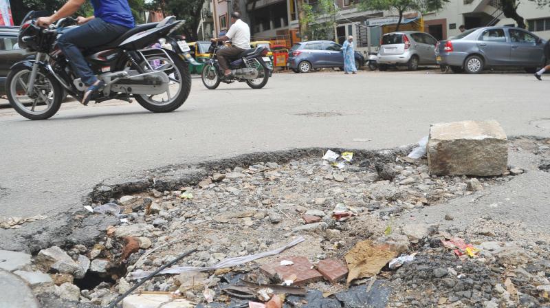 A huge pothole at Kaadu Malleswara Temple Road in Malleswaram. (Photo: DC)